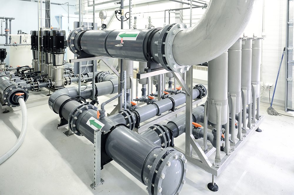 new shiny pipes and large pumps in industrial boiler room